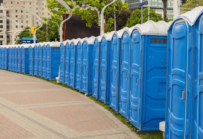 a line of brightly-colored portable restrooms, perfect for outdoor festivals and concerts in Dover